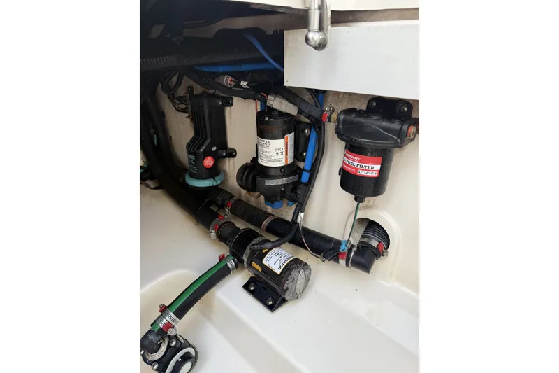 Slide: The Image of Engine compartment of 2016 Boston Whaler 330 Outrage, showcasing fuel filter and pump system. - 36