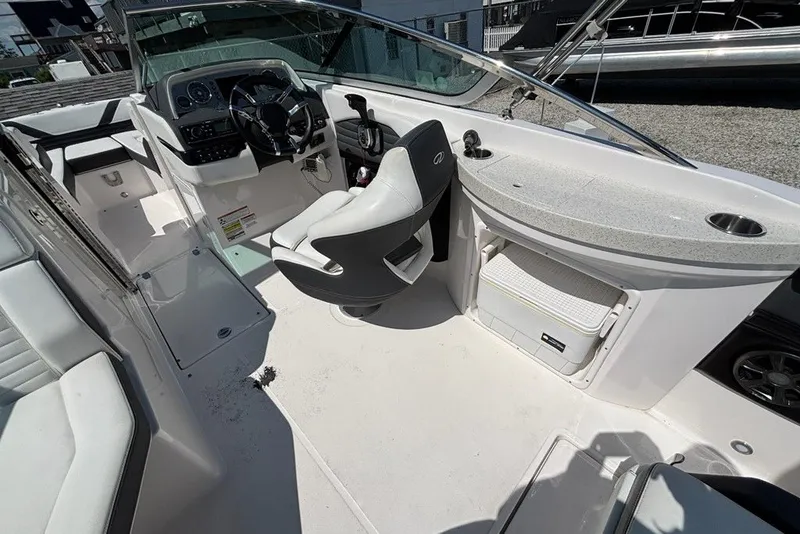 Slide: The Image of 2016 Regal 24 FasDeck boat interior with steering wheel, seating, and storage compartments. - 9