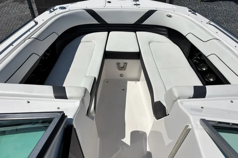 Slide: The Image of 2016 Regal 24 FasDeck boat interior with white seating and cup holders. - 2