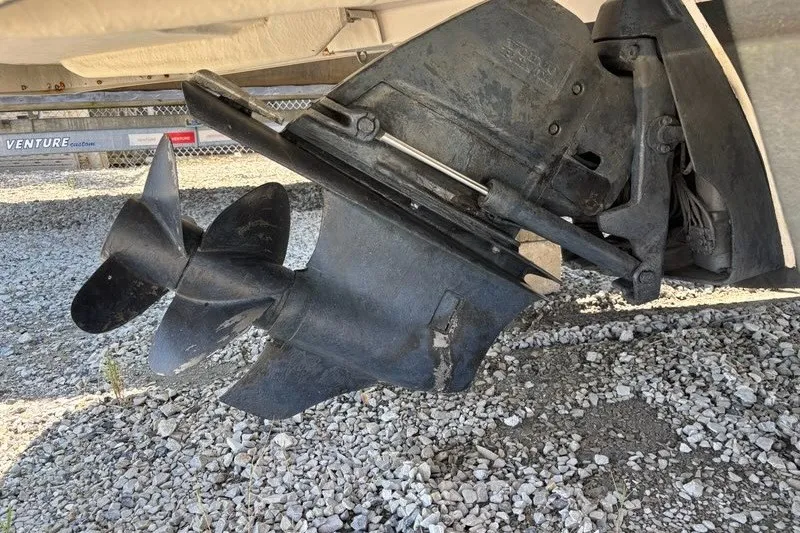 Slide: The Image of Close-up of a 2016 Regal 24 FasDeck boat propeller on gravel surface. - 17
