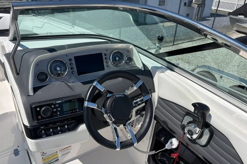 Slide: The Image of Cockpit of 2016 Regal 24 FasDeck boat with steering wheel and control panel. - 7