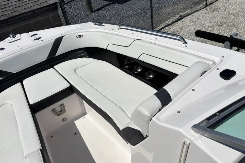 Slide: The Image of 2016 Regal 24 FasDeck boat interior with white seating and cup holders. - 4