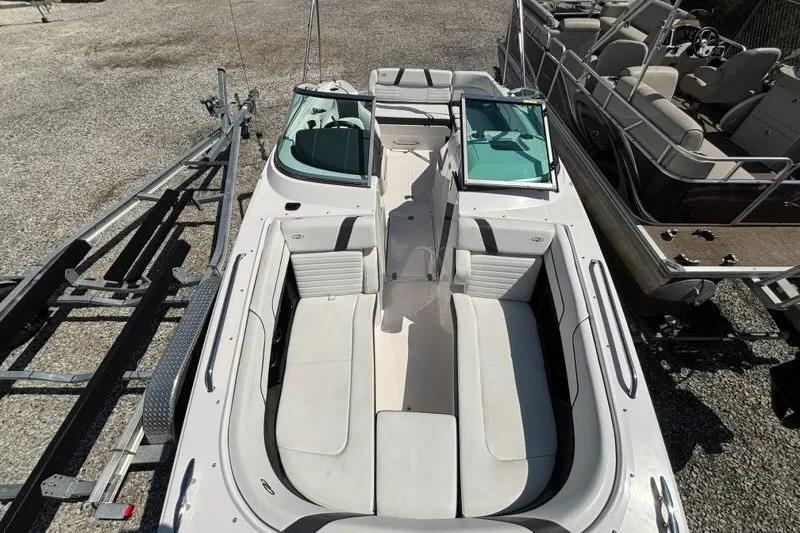 Slide: The Image of 2016 Regal 24 FasDeck boat with spacious seating and sleek design, parked on a trailer. - 5