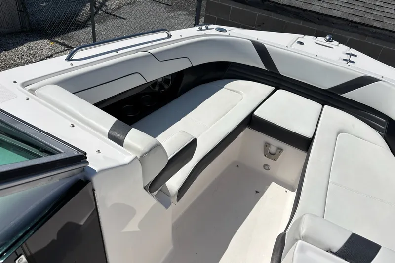 Slide: The Image of 2016 Regal 24 FasDeck boat interior with white seating and black accents. - 3