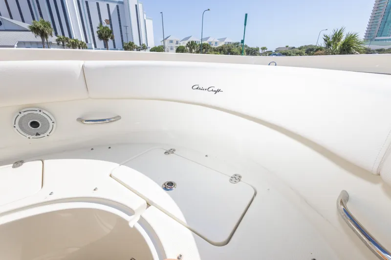 Slide: The Image of Interior view of 2023 Chris-Craft Catalina 30 boat, featuring sleek white seating and speaker. - 38