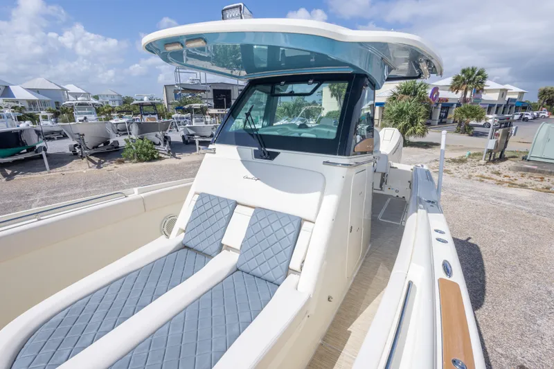 Slide: The Image of 2023 Chris-Craft Catalina 30 boat with luxurious seating and sleek design in a marina setting. - 43