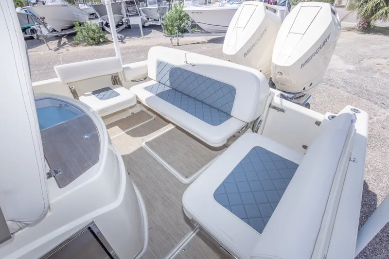 Slide: The Image of 2023 Chris-Craft Catalina 30 boat interior with cushioned seating and dual Mercury engines. - 55