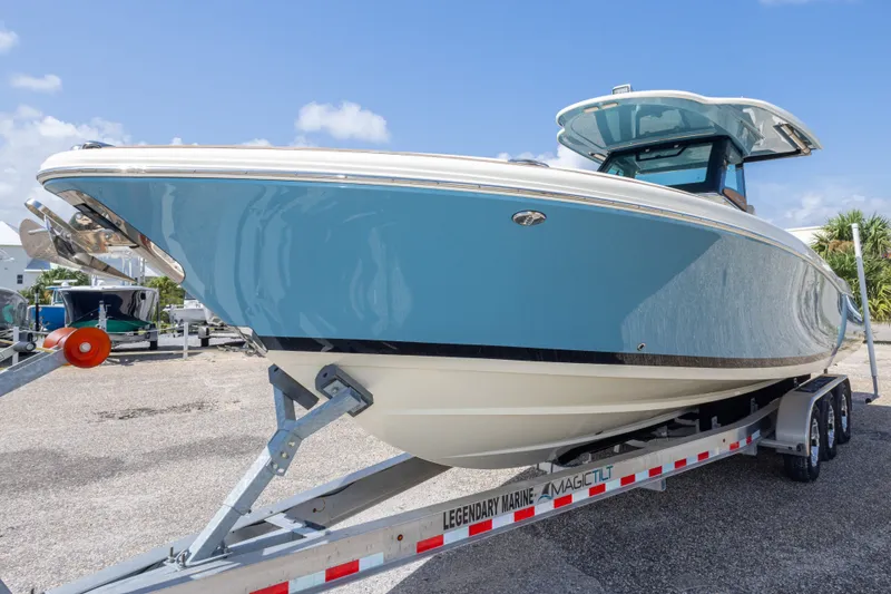 Slide: The Image of 2023 Chris-Craft Catalina 30 boat on trailer, blue hull, sunny day. - 16