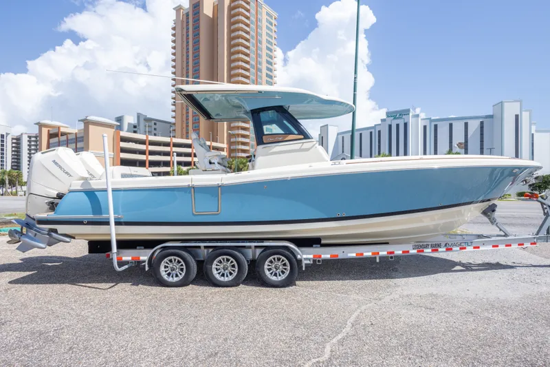Slide: The Image of 2023 Chris-Craft Catalina 30 boat on trailer, urban background, clear sky. - 10