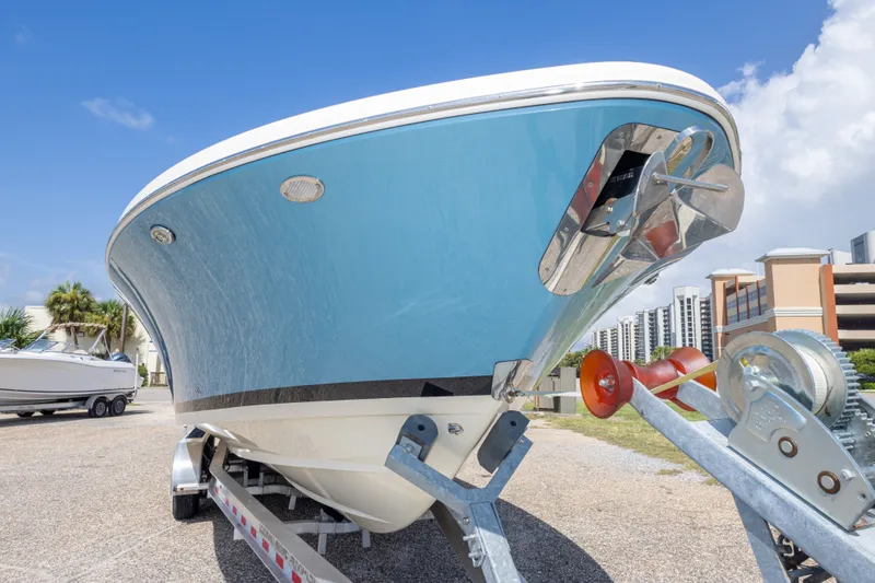 Slide: The Image of 2023 Chris-Craft Catalina 30 boat on trailer, blue hull, urban background. - 18