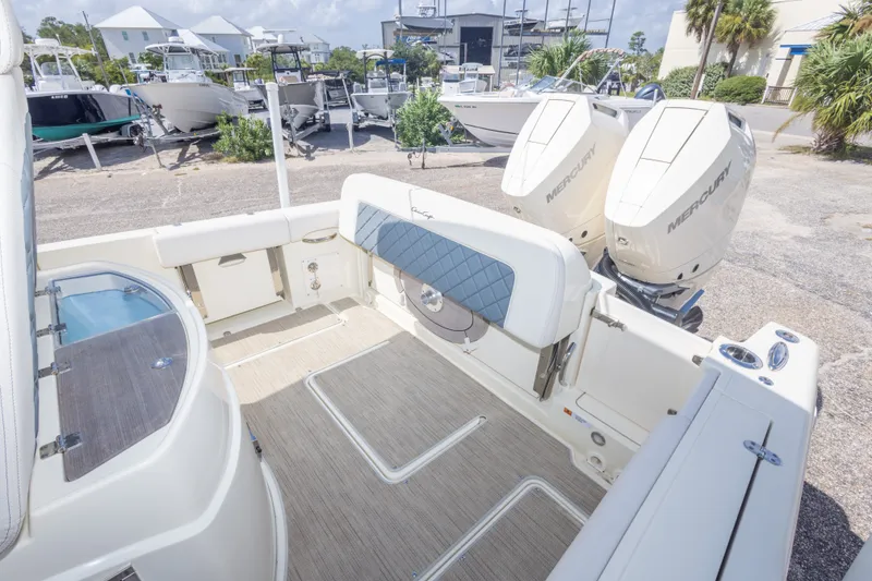 Slide: The Image of 2023 Chris-Craft Catalina 30 boat interior with dual Mercury engines, docked outdoors. - 48