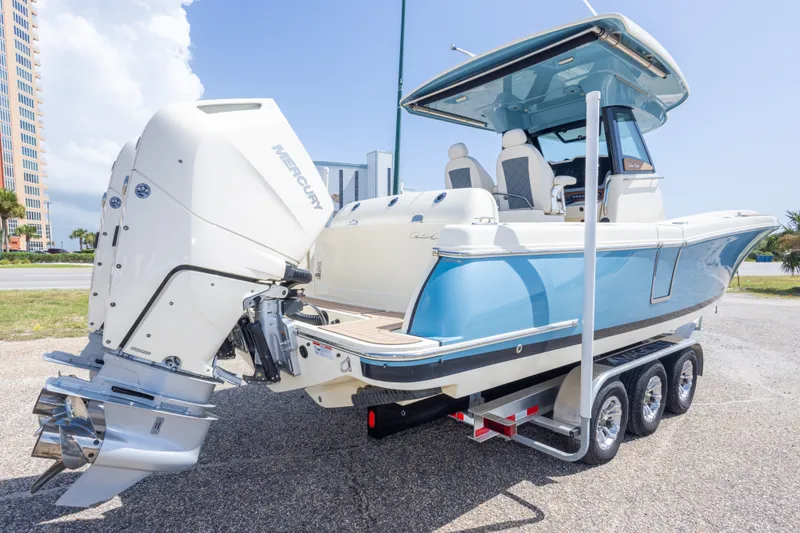 Slide: The Image of 2023 Chris-Craft Catalina 30 boat on trailer, featuring dual Mercury engines. - 11