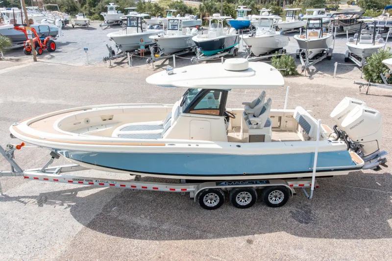 Slide: The Image of 2023 Chris-Craft Catalina 30 boat on trailer, displayed in a marina setting. - 3