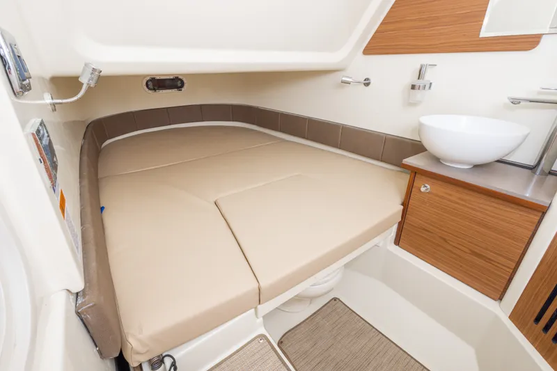 Slide: The Image of 2023 Chris-Craft Catalina 30 cabin interior with beige seating and modern sink. - 35
