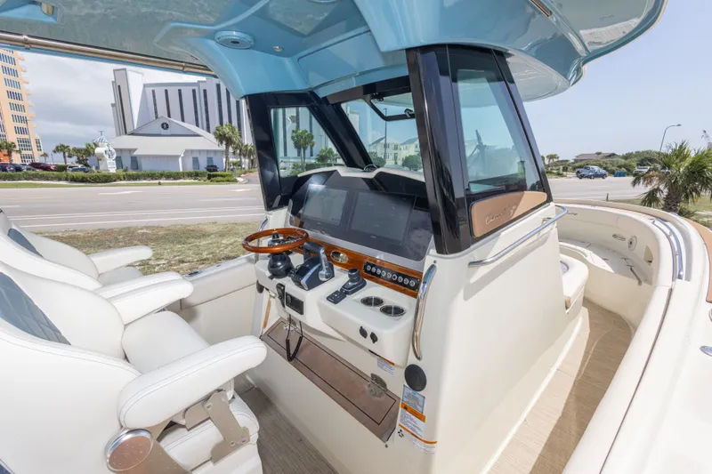 Slide: The Image of 2023 Chris-Craft Catalina 30 helm with modern controls and luxurious seating. - 30