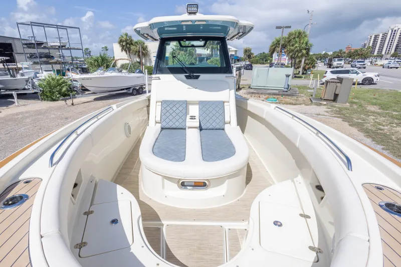 Slide: The Image of 2023 Chris-Craft Catalina 30 boat with spacious seating and elegant design in a marina setting. - 40