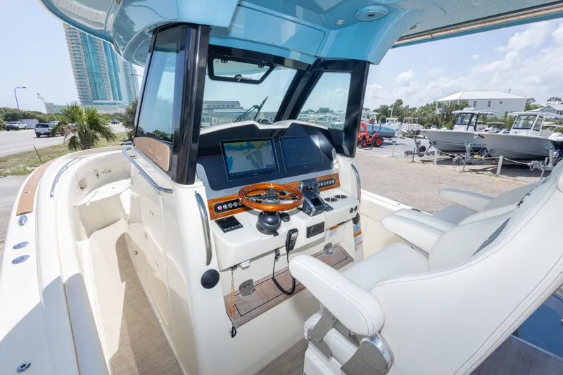 Slide: The Image of 2023 Chris-Craft Catalina 30 helm with modern controls and luxurious seating. - 28