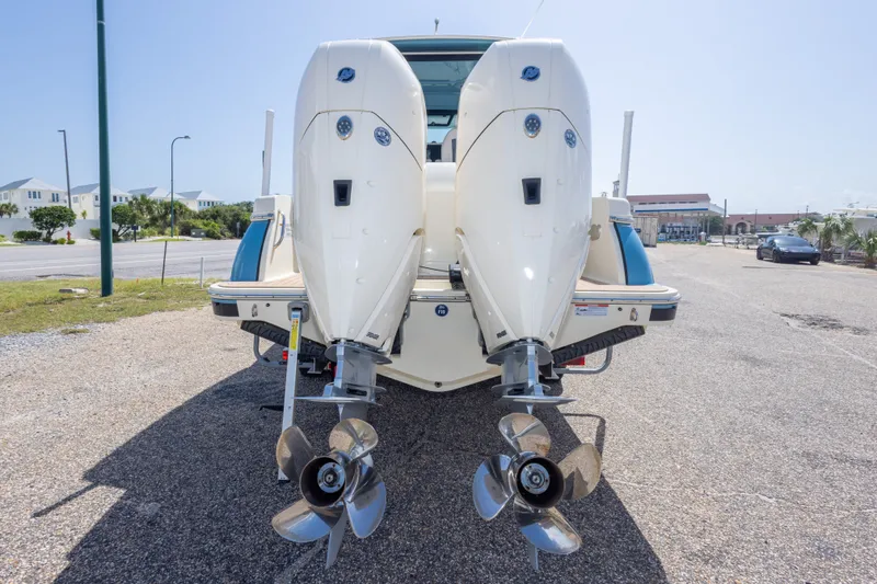 Slide: The Image of 2023 Chris-Craft Catalina 30 with dual outboard engines, parked on a sunny day. - 13