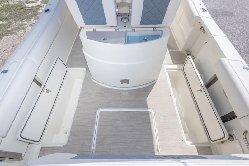 Slide: The Image of 2023 Chris-Craft Catalina 30 boat interior with open storage compartments and seating. - 56