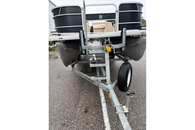 Slide: The Image of 2016 Godfrey Sweetwater 2286 pontoon boat on trailer, parked on wet pavement. - 4