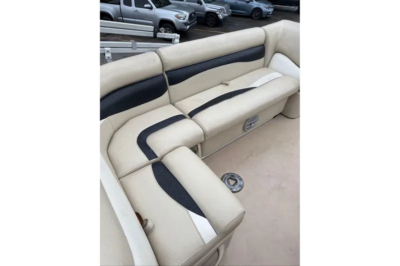 Slide: The Image of 2016 Godfrey Sweetwater 2286 boat interior with beige and black seating. - 13