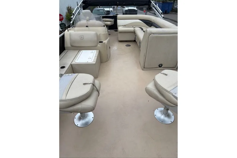 Slide: The Image of 2016 Godfrey Sweetwater 2286 boat interior with beige seating and helm. - 9
