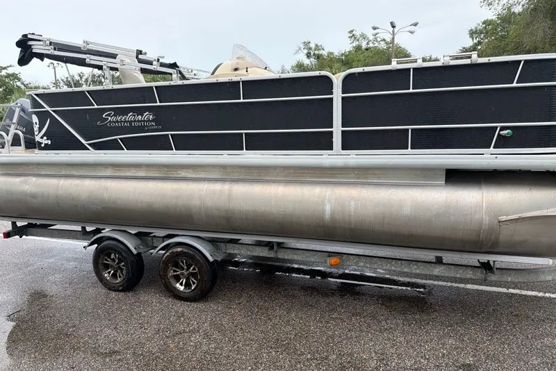 The Image of 2016 Godfrey Sweetwater 2286 pontoon boat on trailer, side view. - 0