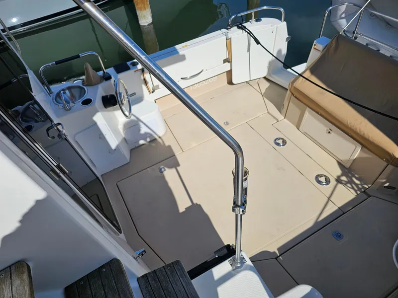 Slide: The Image of The image shows the cockpit of a 2014 Ranger Tugs 31-CB with seating area and helm. - 18