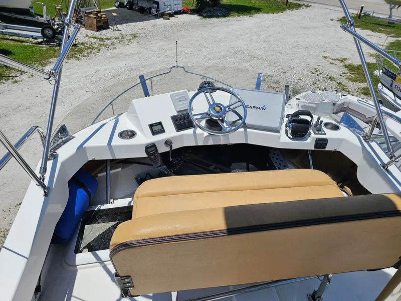 Slide: The Image of The image shows the helm of a 2014 Ranger Tugs 31-CB with a beige seat. - 12