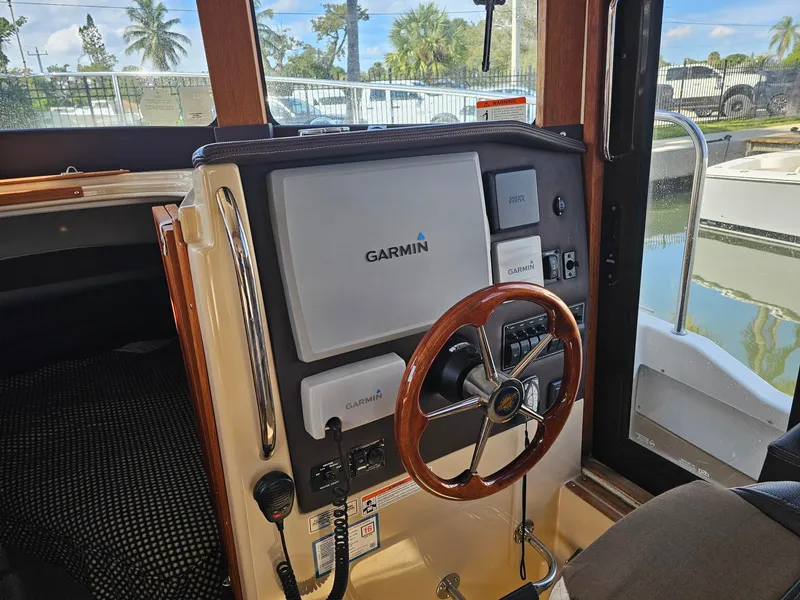 Slide: The Image of The image shows the helm of a 2014 Ranger Tugs 31-CB with a Garmin navigation system. - 32