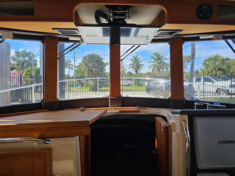 Slide: The Image of Interior of a 2014 Ranger Tugs 31-CB with wood finish and large windows. - 31