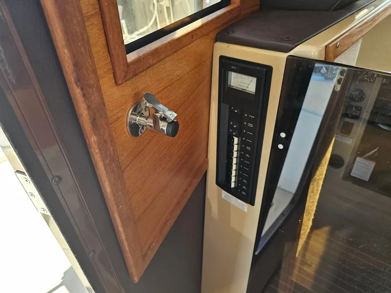 Slide: The Image of Interior view of a 2014 Ranger Tugs 31-CB with a wooden door and control panel. - 29
