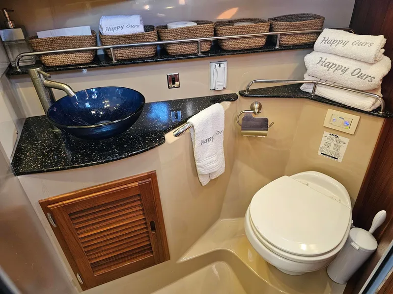Slide: The Image of The image shows a stylish boat bathroom with a modern sink and neatly arranged towels. - 37