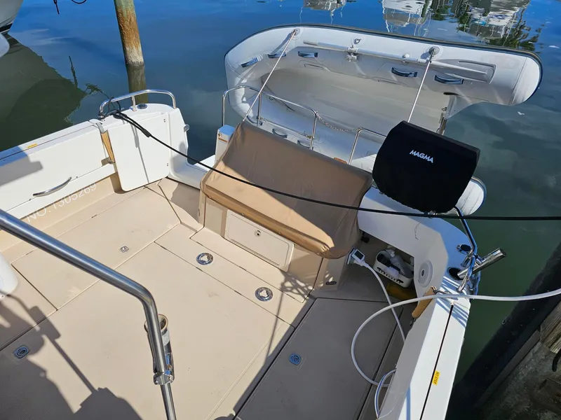 Slide: The Image of The image shows the cockpit of a 2014 Ranger Tugs 31-CB with seating and a grill. - 24