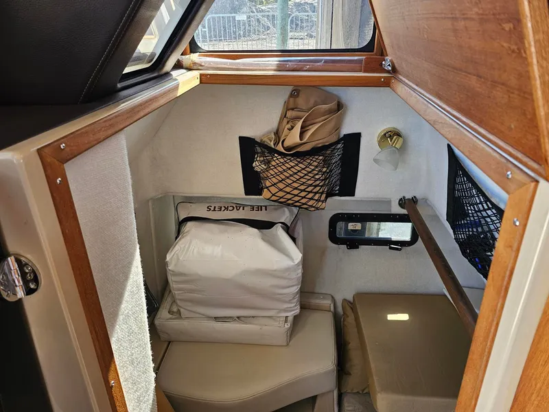 Slide: The Image of The interior of a 2014 Ranger Tugs 31-CB features a cozy cabin with storage and seating. - 28