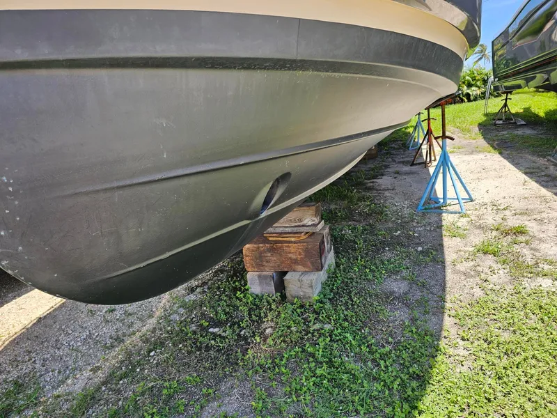 Slide: The Image of The hull of a 2014 Ranger Tugs 31-CB rests on wooden blocks outdoors. - 7