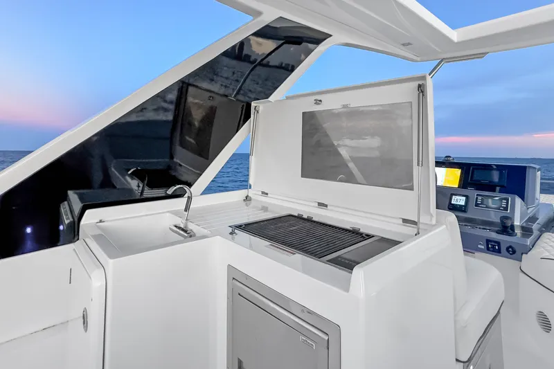 Slide: The Image of Galeon 500 Fly 2021 yacht with outdoor kitchen and grill at sunset. - 24
