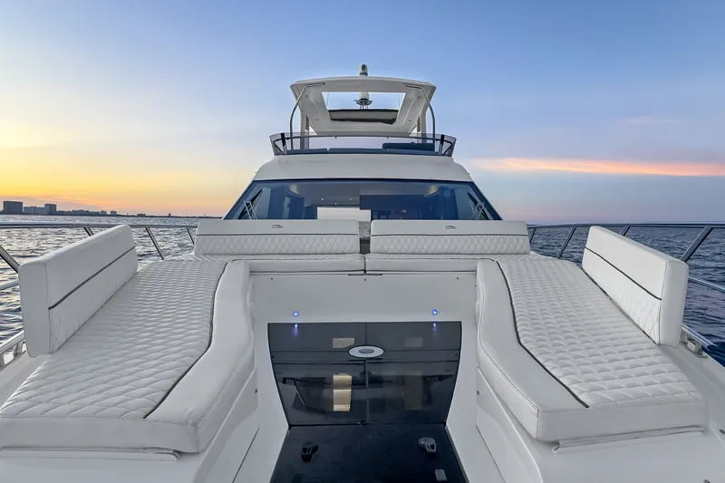 Slide: The Image of Luxurious 2021 Galeon 500 Fly yacht deck at sunset, featuring elegant white seating. - 25
