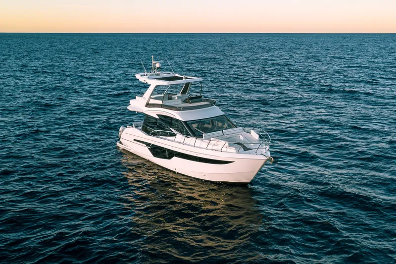 Slide: The Image of 2021 Galeon 500 Fly yacht cruising on open sea at sunset. - 9