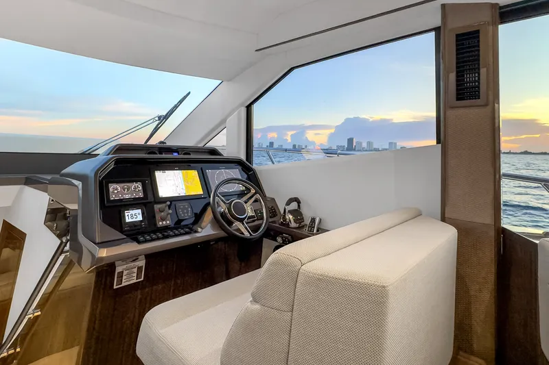 Slide: The Image of Interior helm of 2021 Galeon 500 Fly yacht with ocean view at sunset. - 16