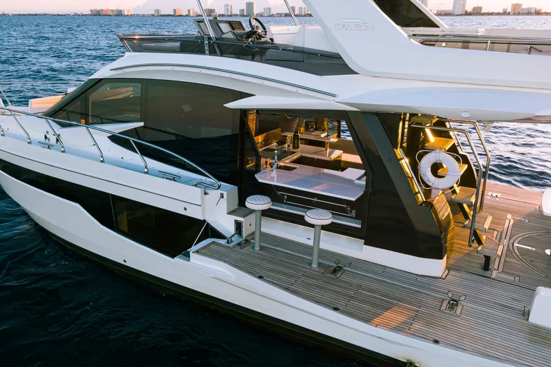 Slide: The Image of 2021 Galeon 500 Fly yacht on water, showcasing luxurious deck and modern design. - 7