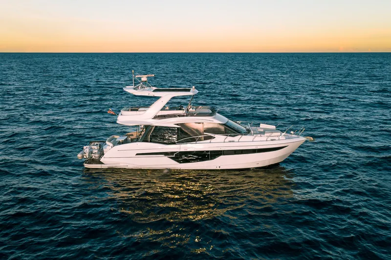 Slide: The Image of 2021 Galeon 500 Fly yacht cruising on open sea at sunset. - 8