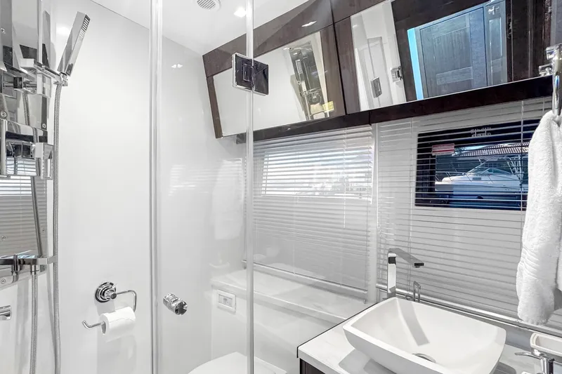 Slide: The Image of Luxurious bathroom interior of 2021 Galeon 500 Fly yacht with modern fixtures and window view. - 32