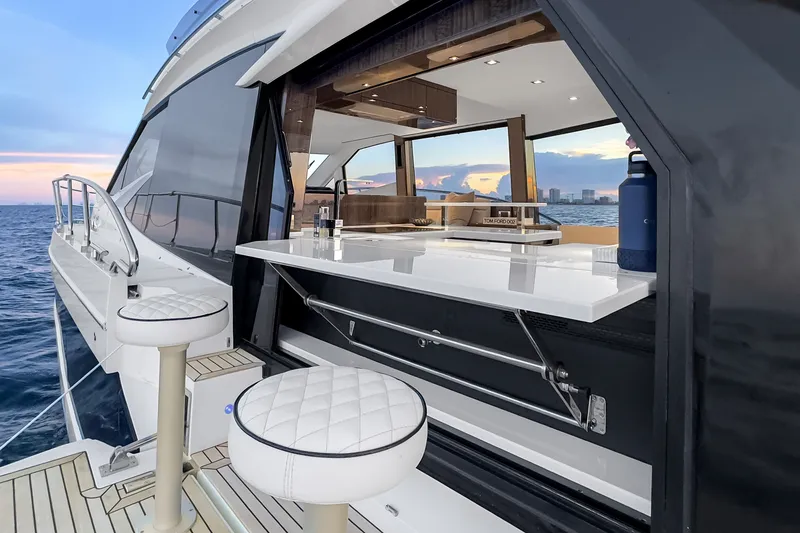 Slide: The Image of Luxurious 2021 Galeon 500 Fly yacht with elegant outdoor seating and ocean view. - 11