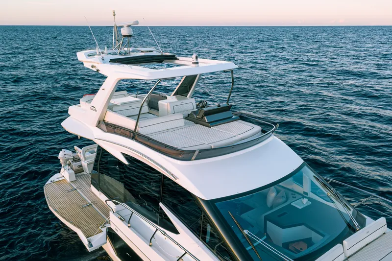 Slide: The Image of 2021 Galeon 500 Fly yacht cruising on open sea at sunset. - 6