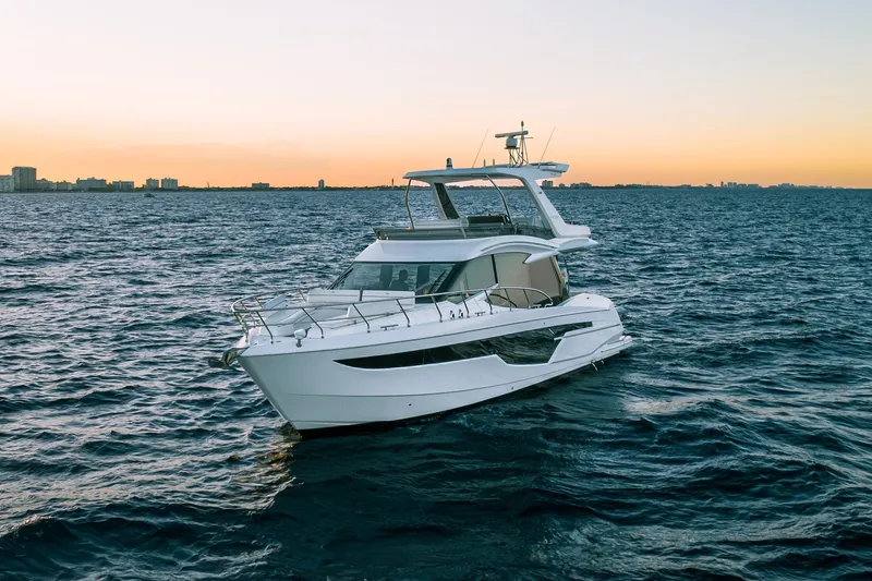 Slide: The Image of 2021 Galeon 500 Fly yacht cruising at sunset on open water. - 34