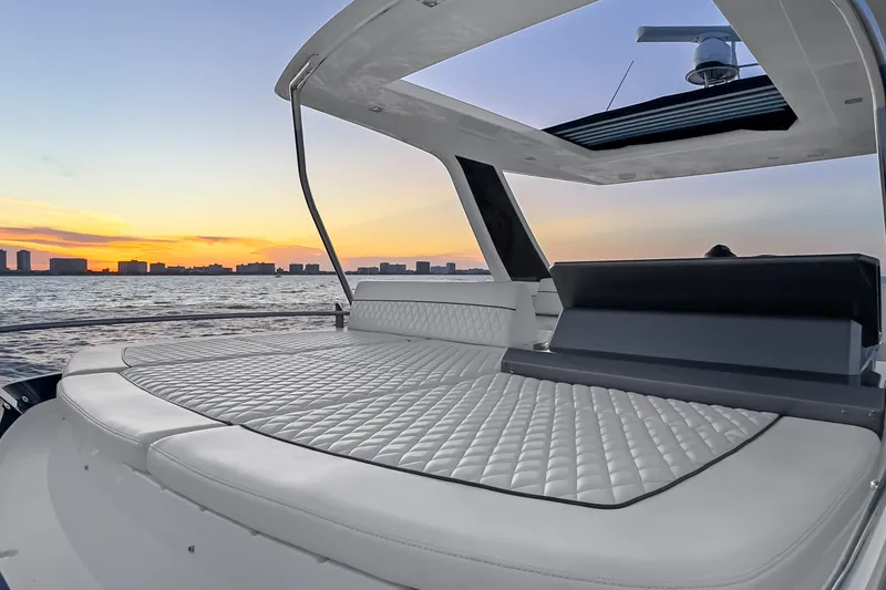 Slide: The Image of Luxurious 2021 Galeon 500 Fly yacht deck at sunset, featuring elegant seating and ocean view. - 23