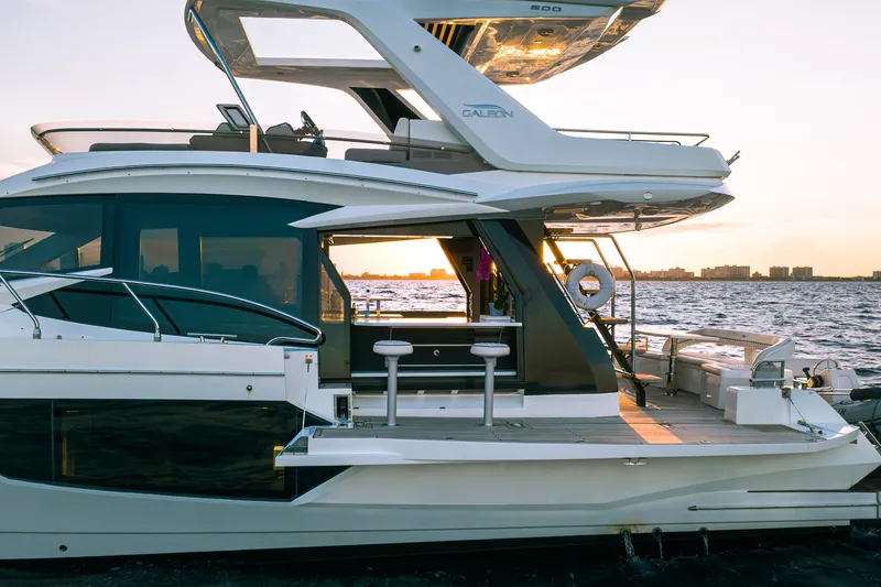 Slide: The Image of 2021 Galeon 500 Fly yacht at sunset on the water, showcasing sleek design and luxury features. - 35