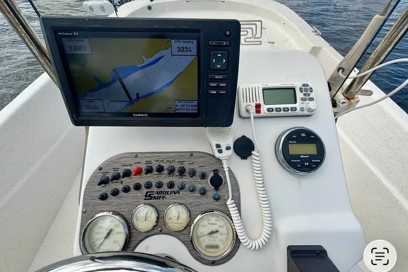 Slide: The Image of Control panel of a 2017 Carolina Skiff 218 DLV with navigation and communication equipment. - 8