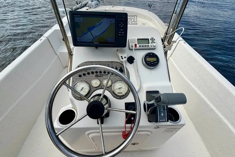 Slide: The Image of 2017 Carolina Skiff 218 DLV boat console with steering wheel and navigation equipment. - 7